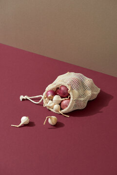 The reusable organza net bag for shopping with onion and garlic