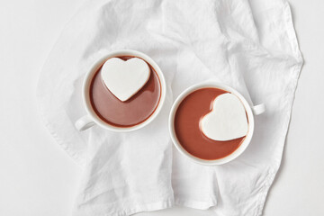 Heart cakes in two cups with chocolate.