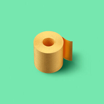 Creative backdrop from golden painted toilet roll paper on a cyan color background