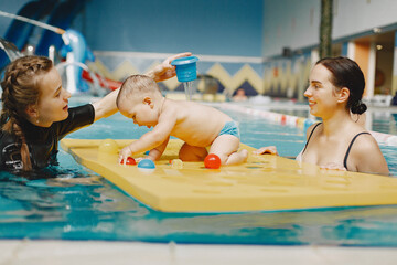 Little cute baby boy. Instructor with kid. Mother with son.