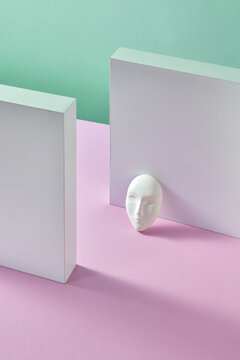 Abstract plaster walls with face mask.
