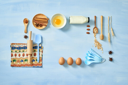 Set of products for making dough on pastel blue background