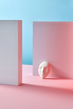 Gypsum mask is leaning on a wall.