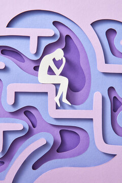 Close-up handmade paper thinker inside labyrinth of human brain.