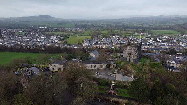 Aerial view of Clitheroe castle with a union jack flying. Flying over Clitheroe park in the ribble valley