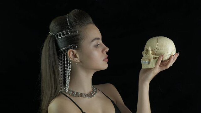 Skull on fashion poses. Stylish girl shared a skull.