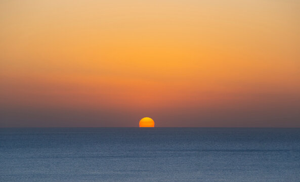 The sun sets in the sea