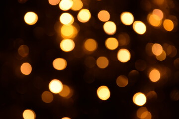 Warm lights blurred bokeh abstract on dark background, rozmyte światełka na ciemnym tle lampki świąteczne - obrazy, fototapety, plakaty