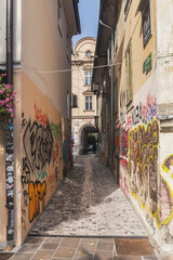 Ljubljana, Slovenia, October 2020: cobblestone street in Slovenia disfigured by graffiti