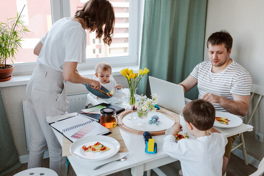 Working mother giving food to family