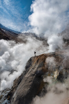 Man on the top of volcanic rock, volcano Mutnovsky.
