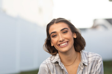 Smiling happy young Italian/Armenian-American woman in backyard 0283