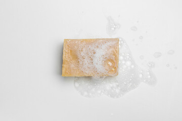Soap bar and foam on white background, top view. Mockup for design