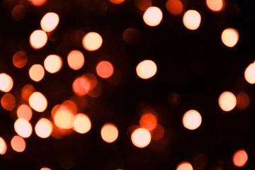Warm lights blurred bokeh abstract on dark background, rozmyte światełka na ciemnym tle lampki świąteczne - obrazy, fototapety, plakaty