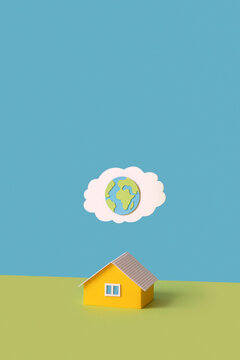Papercraft house and cloud with globe.
