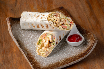 Chicken Doner-kebab or roll with chicken and mustard sauce on a plate