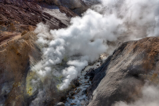 Stone cleft with smoking fumaroles, volcano Mutnovsky.