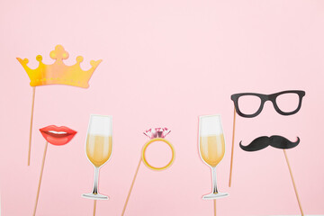 Valentine's day, love, romantic concept. Red heart, champagne glass, mustaches and lips paper prop on pink background. Greeting card. Flat lay, top view, copy space