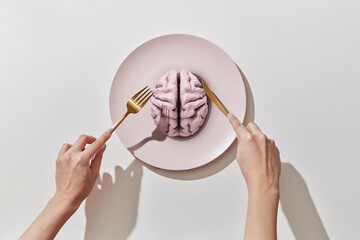 Plate with human brain ahd women's hands.
