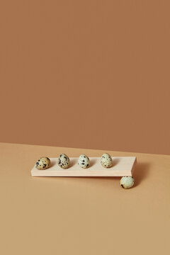 Wooden board with quail eggs.