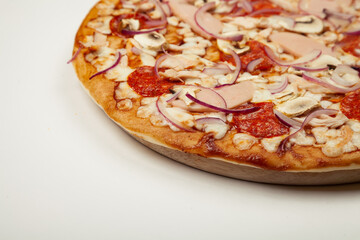 Delicious pizza BBQ sauce, mozzarella cheese, ham, pepperoni, smoked chicken, mushrooms, red onion. Close-up. Restaurant flyer and poster.