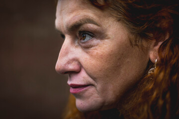 Portrait of middle aged woman with vitiligo and orange hair