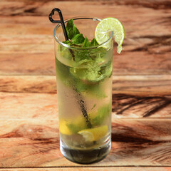 Lemon Mojito served in a glass over a rustic wooden background,a refreshing drink for summer days, selective focus on top