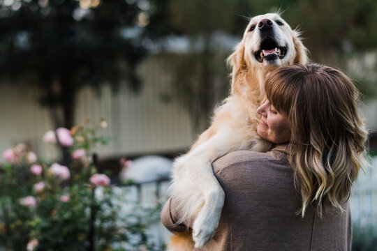 woman hugging a dog
