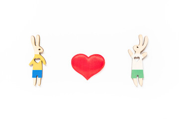 Valentine's day lgbt, love, romantic concept. Couple of rabbits, a boy and a boy, with red heart on white background. Flat lay, top view