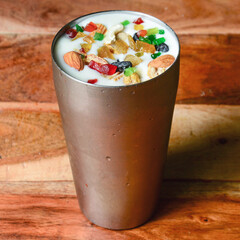 Patiala Lassi is the famous Punjabi drink,This delicious and yummy Indian lassi patiala is made with fresh yogurt, sugar,cardamon, saffron and topped with dry fruits and nuts, selective focus on top