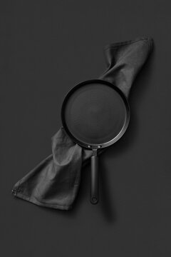 Cooking black pan served textile towel.