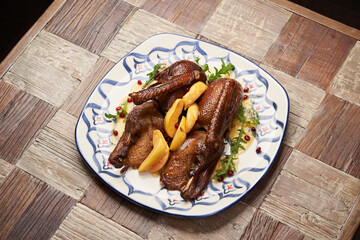 Roasted duck with quince on wooden table background