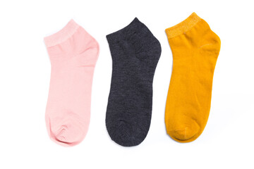 several colored new short socks on a white background, top view