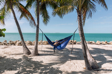 Man relaxing in a hammock by the ocean
