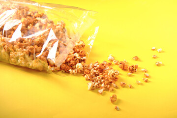 Caramel popcorn in a package on a yellow background