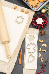 Fototapeta na wymiar Preparing Christmas treat. Rolling pin for dough. Cookie cutter molds. Metal form with berries and fir branches
