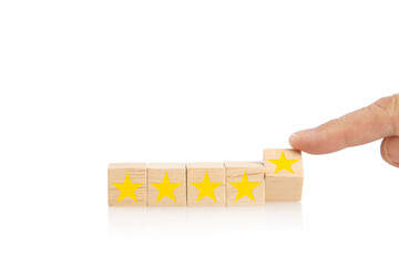 Hand flipping five stars printed on wooden blocks. Customer satisfaction and experience feedback...