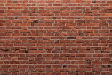 Fototapeta premium dark brown old brick wall, base for design, brickwork background