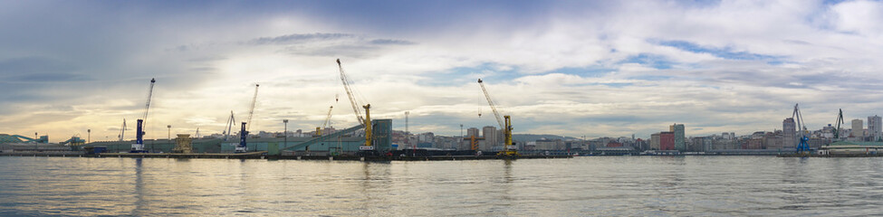 Fototapeta na wymiar a panorama view of the industrial port and harbor in La Coruna in golden morning light