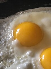 Eggs, frying in a pan, close up, breakfast food
