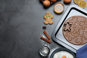 Flat lay composition with homemade Christmas cookies on grey table, space for text. Gingerbread men