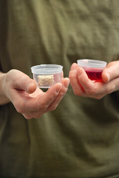 Woman Hands Takes Communion In One Time Use Containers