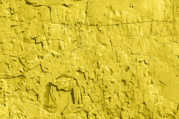 Concrete yellow colorful wall surface texture. Abstract grunge bright illuminating color background with aging effect. Copyspace.
