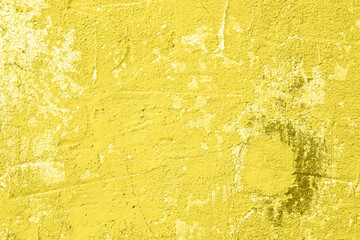 Concrete yellow colorful wall surface texture. Abstract grunge bright illuminating color background with aging effect. Copyspace.
