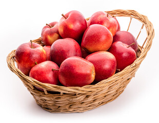 Red apples in a wicker basket. Isolate on white background