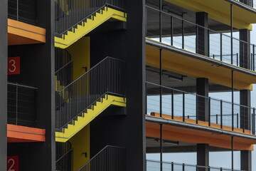 bright yellow external fire escape of new multilevel parking building