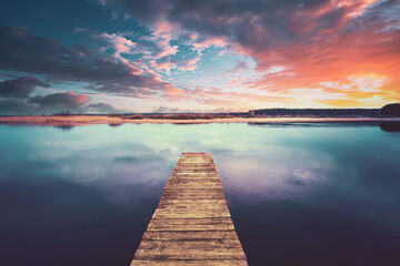 Colorful Sunset Sunrise Dramatic Sky Above Wooden Boards Pier On Calm Water Of Lake, River. Nature,...