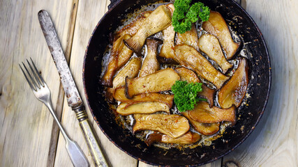 Selective focus. Fried eringi mushrooms in a pan. Vegan lunch.