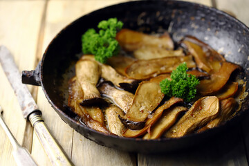 Selective focus. Fried eringi mushrooms in a pan. Vegan lunch.
