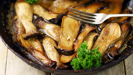 Selective focus. Fried eringi mushrooms in a pan. Vegan lunch.